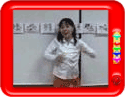 Teacher teaching the rhyme 'Here we go round the mulberry bush'